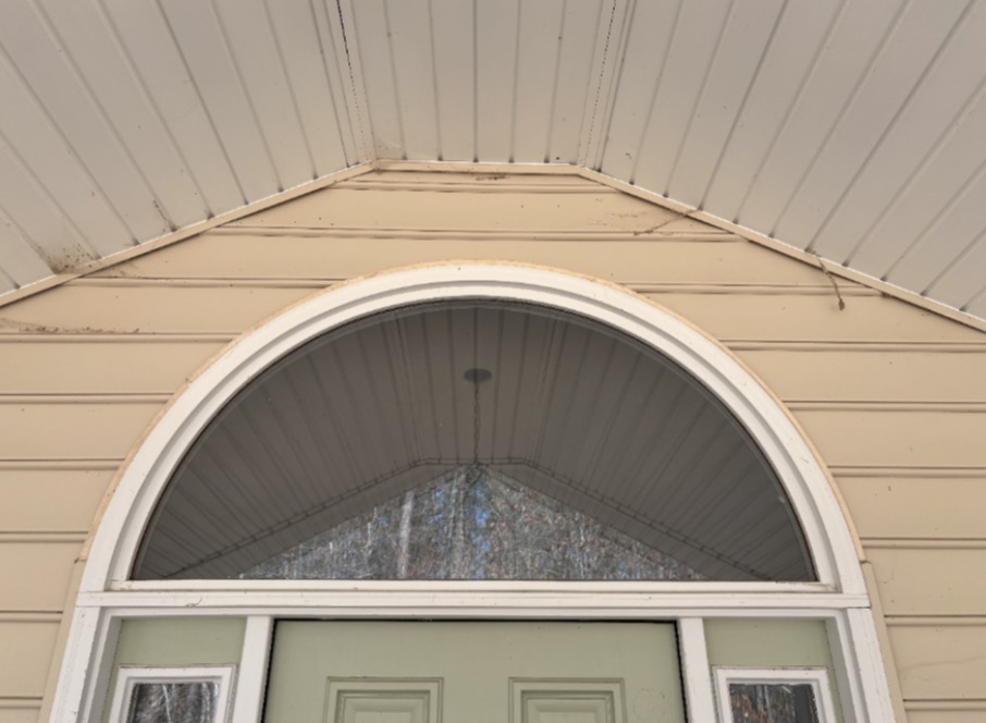 Arched entry & soffit before